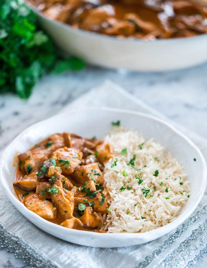 Chicken and Shiitake Coconut Curry a bowl of chicken curry in one half and white rice in the other half