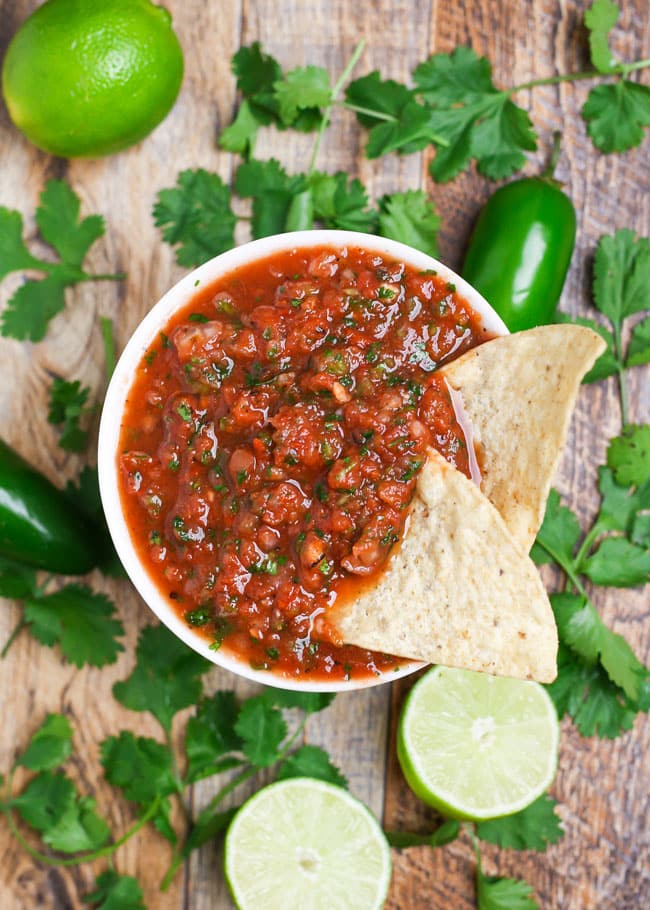 overhead shot of a bowl of homemade salsa with chips