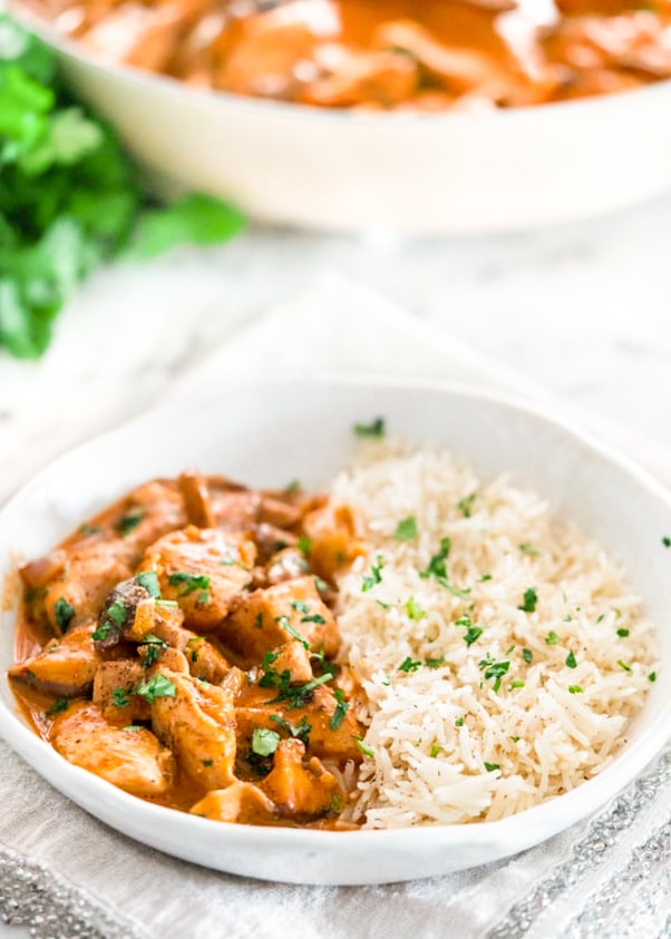 a bowl of chicken and mushroom coconut curry with rice