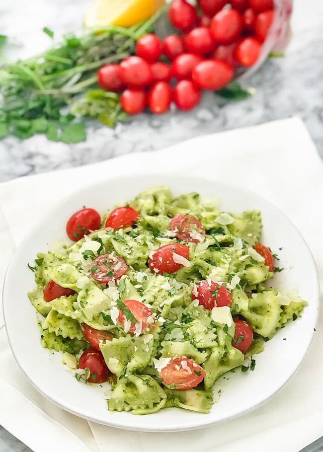pasta tossed with pesto, tomatoes, and parmesan