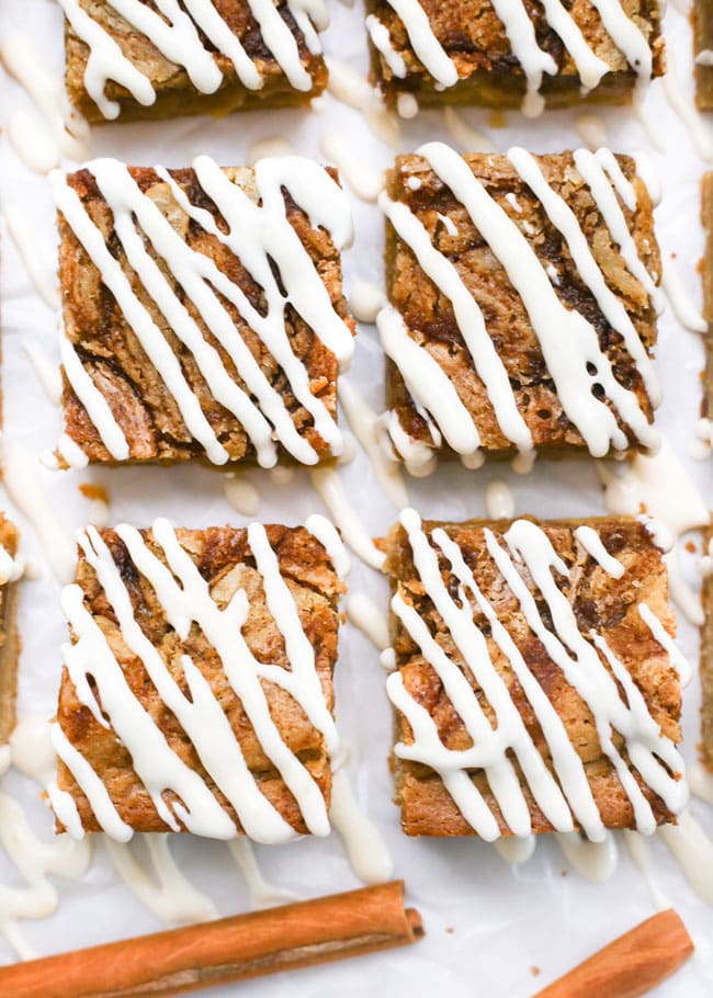an overhead photo of cinnamon roll blondies drizzled with icing
