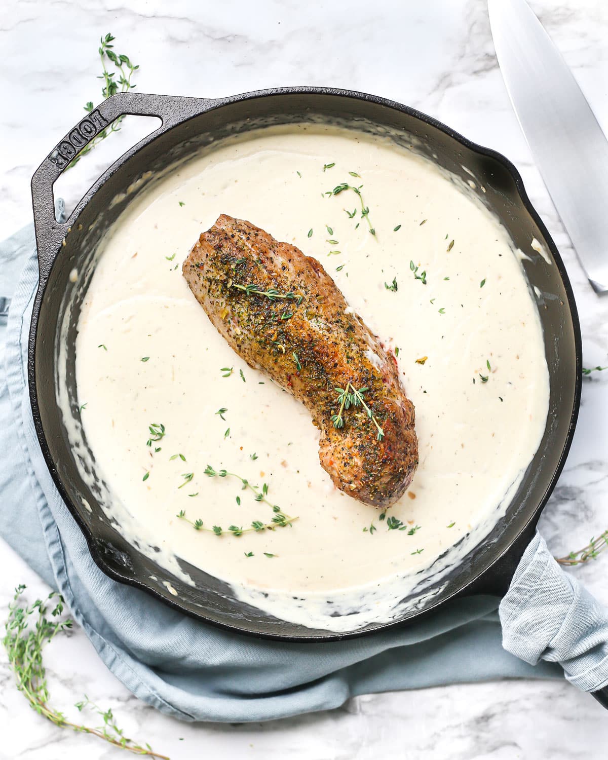 roasted pork loin in a skillet with cream sauce