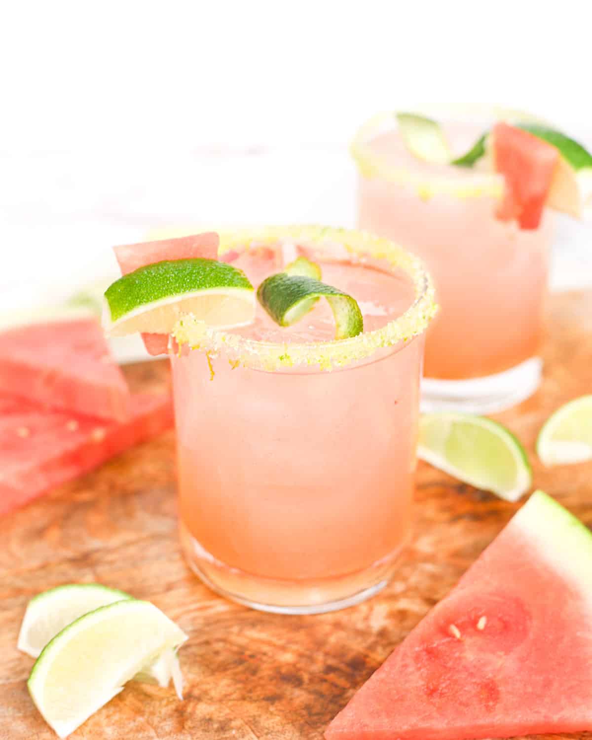 two watermelon margaritas on a platter